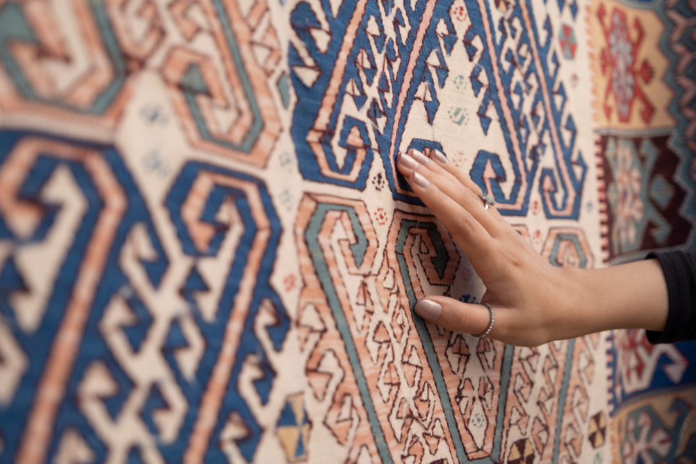 Why do rugs from India give a more luxurious look?